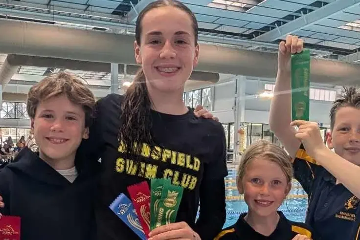 RIBBONS AND RECORDS: Haim and Keziah Wolfe with Vivian and Harvey Knight at the Gurri Wanyarra Wellbeing Centre indoor pool in Bendigo. PHOTO: Helen Knight