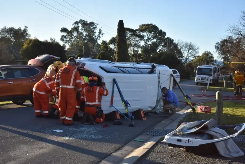 EXTRACTION: Members of the Mansfield SES rescue unit work to free a man trapped in his vehicle following a two car collision in Victoria Street last Wednesday. 