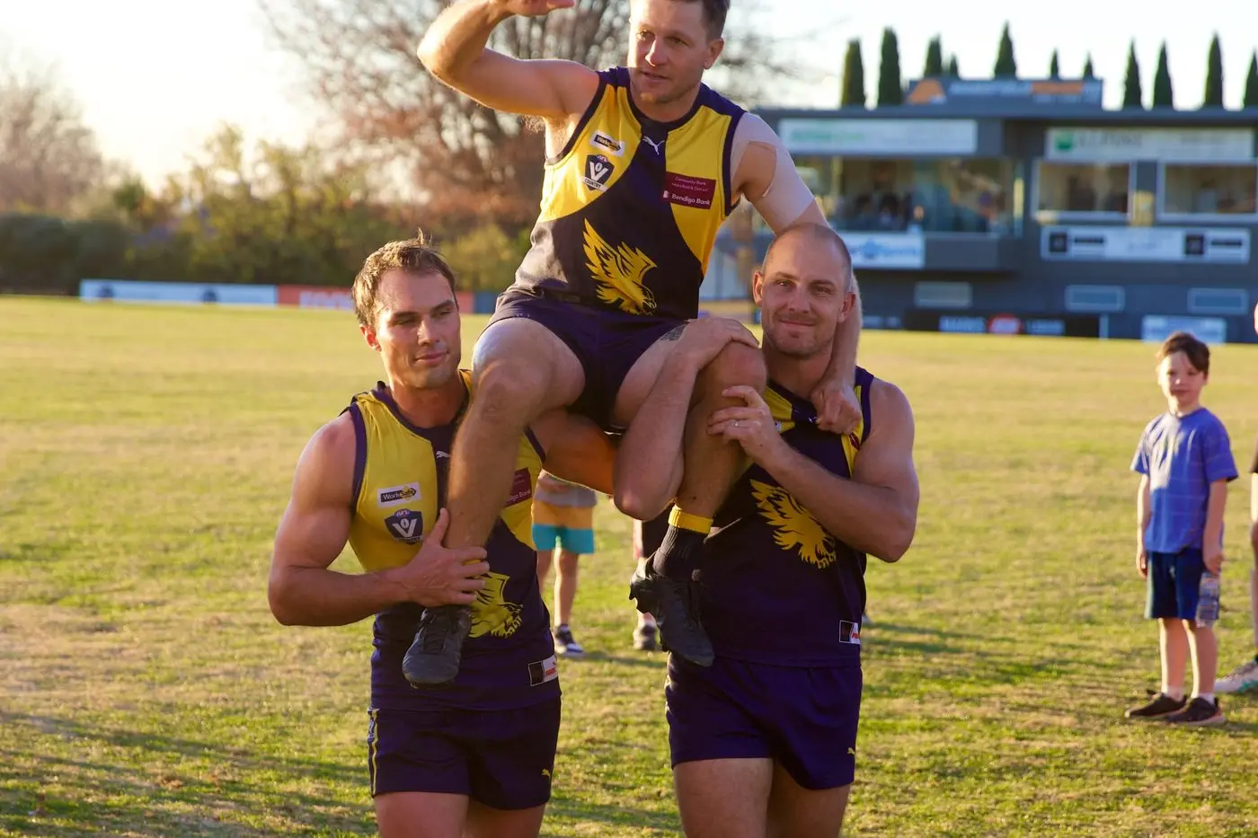 MILESTONE MAN: Jimmy Herridge is chaired off the field by teammates Brett Mahoney and Adam Boshevski after his 300th game for the Mansfield Eagles. PHOTO: Paul Martin