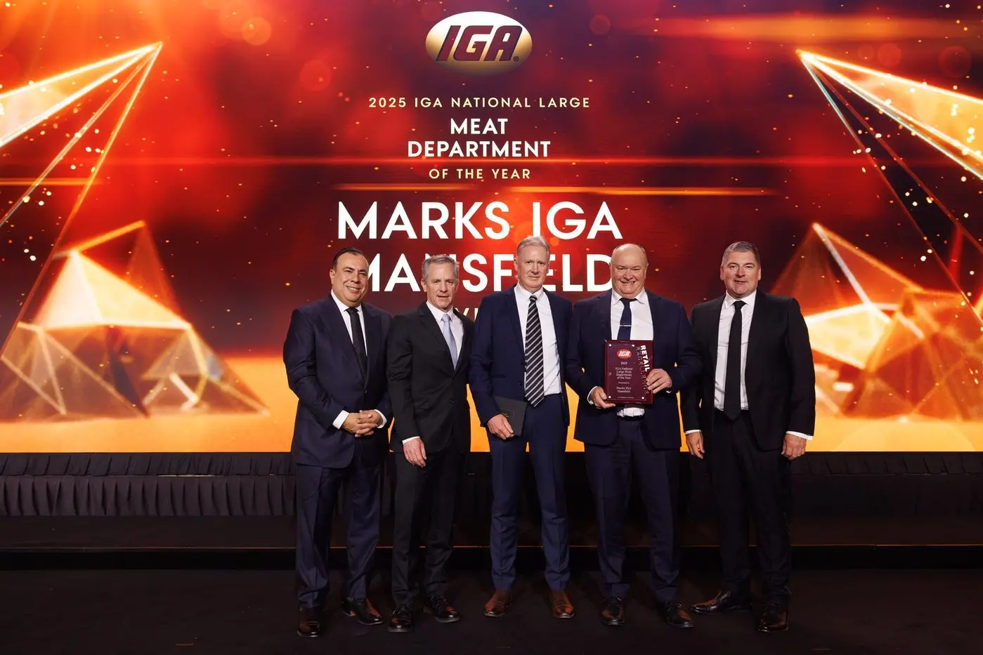 HONOUR: On the stage is Joseph Romeo (left), Doug Jones, Wayne Higgs (Meat Manager, Marks IGA Mansfield), Stephen Marks (Owner, Marks IGA Mansfield), and Grant Ramage. PHOTO: Supplied\\n\\n