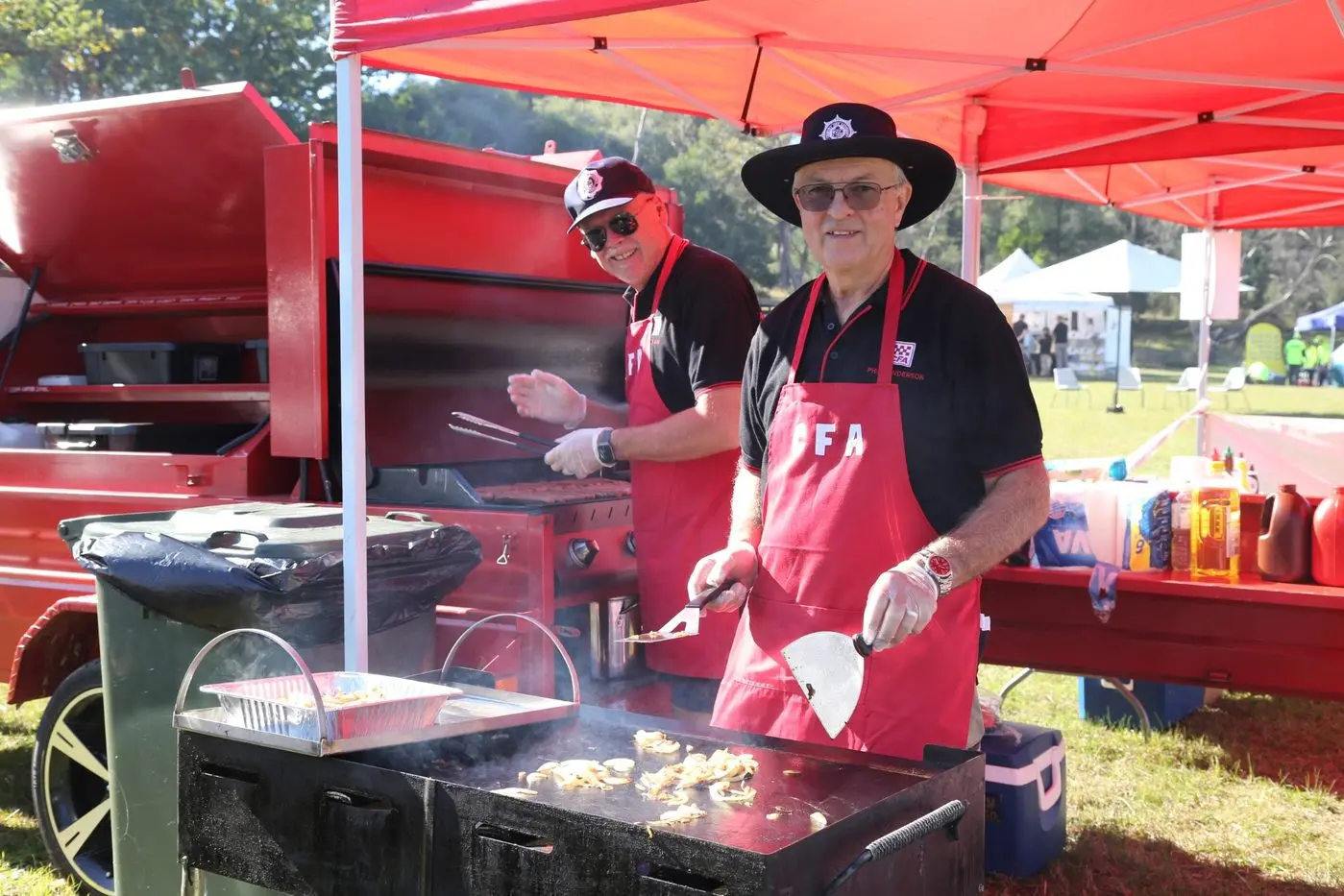 SIZZLING SNAGS: Members of the CFA manned the barbeque on day. PHOTO: Freddie Leong Id:40420