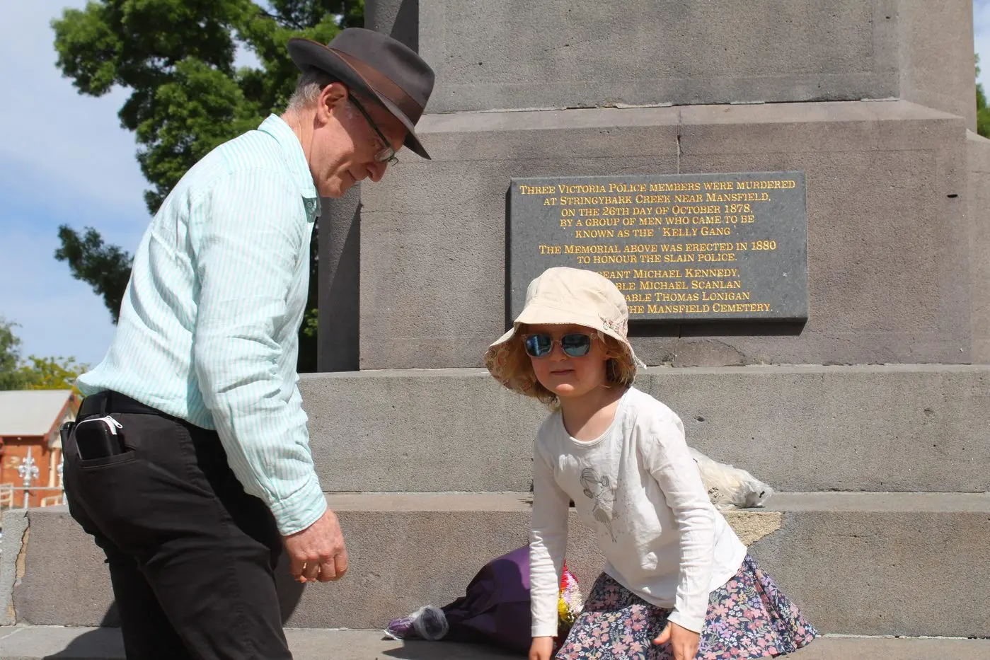 FAMILY MEMORIES: Leo Kennedy, the great grandson of Sergeant Michael Kennedy, and five-year-old Emma Henwood, the trooper\\'s great, great, great grandaughter lay flowers at the Police Monument at Mansfield last Sunday.
