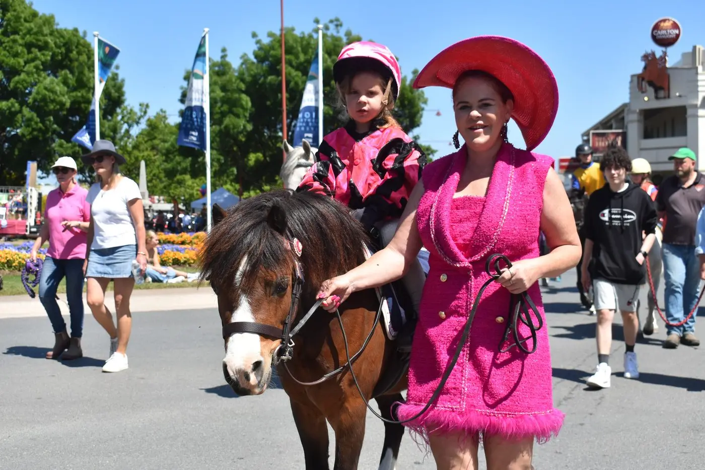 LADIES IN PINK: As part of the High Country Festival Grand Parade on Saturday morning, mother and daughter Louise Drysdale and Tawney stood out among the crowd. Louise and Tawney joined the parade with the Mansfield Pony Club\\'s entry which saw more than 60 floats, cars, animals, bands and orchestra joining the parade. PHOTO: Pam Zierk-Mahoney