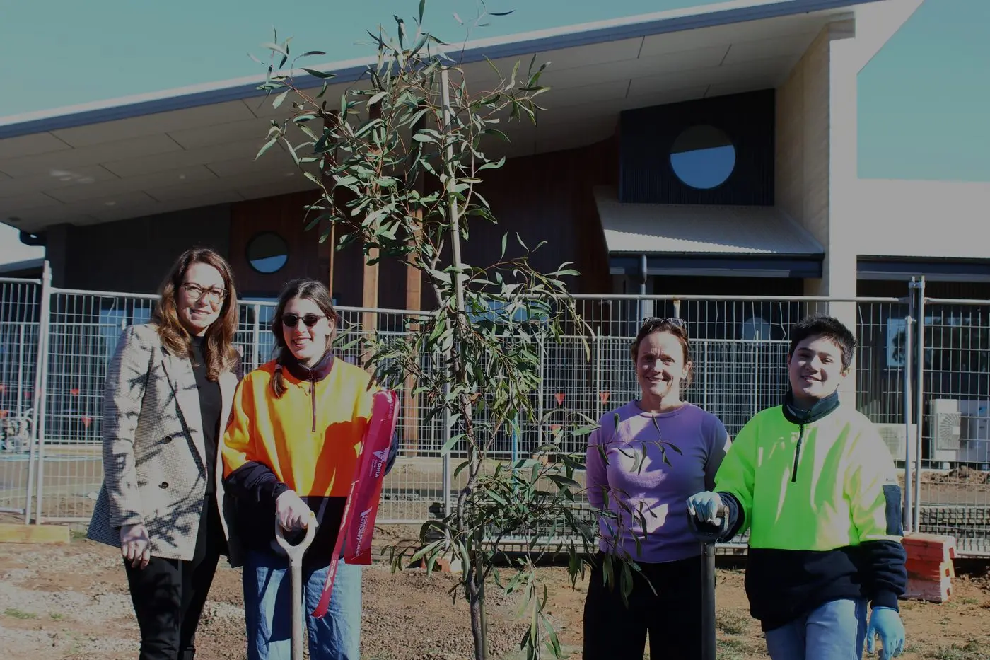 TREE PLANTING: Jaclyn Symes MP (far left) with school principal Kerri Grant (in purple) were assisted by students from the school to plant the tree.