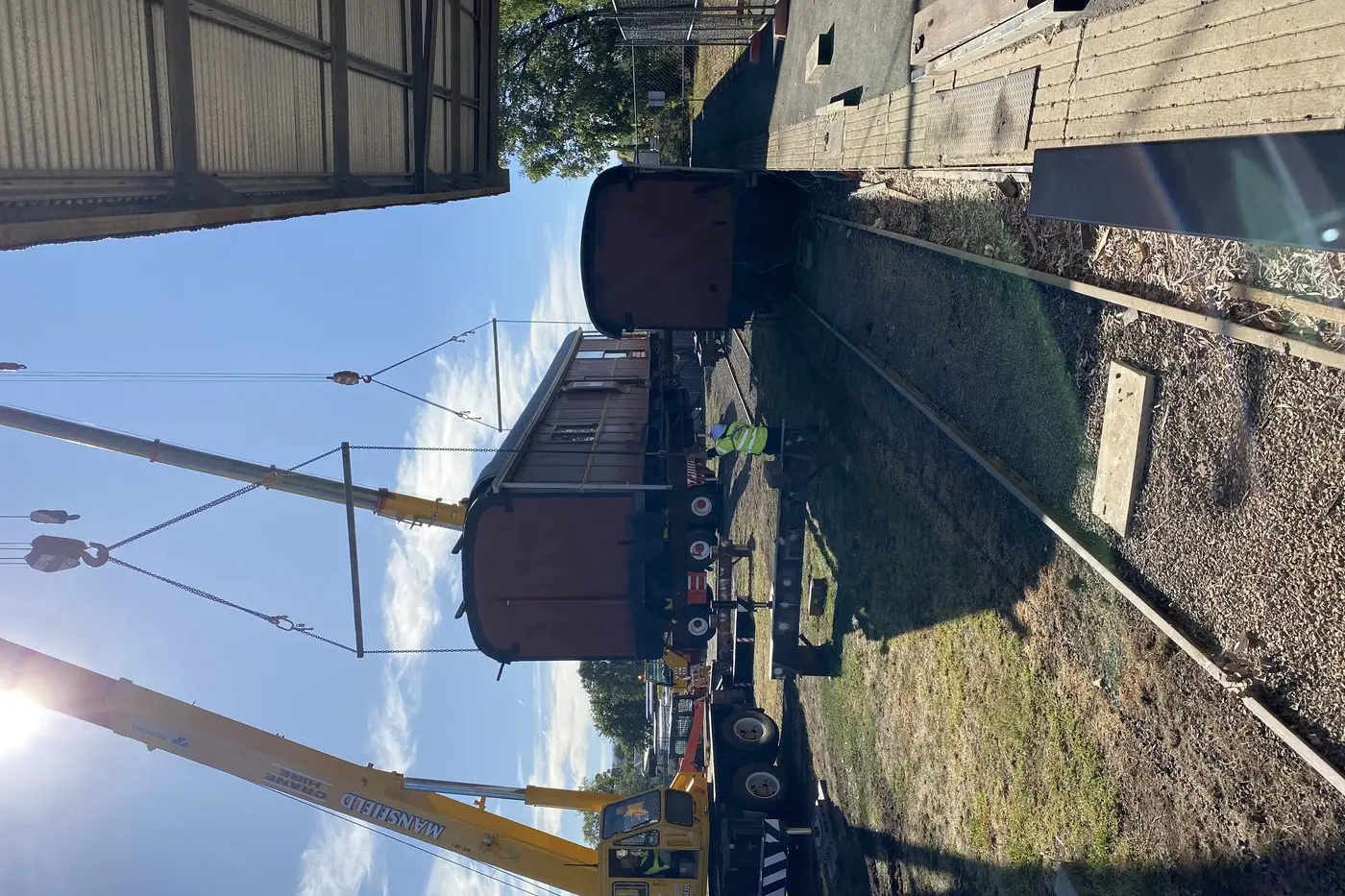 UP IN THE AIR: Cranes lifted the carriage, moving it from its initial resting place along the platform. (PHOTO: Ann Ware) Id:38473