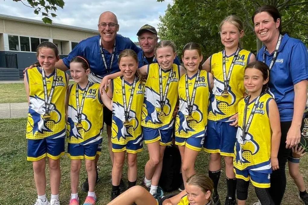 CHAMPIONS: (Back, from left) Matilda Mills, Quinn Walsh, Coach Glenn Thornton, Hannah Bruce, Assistant Coach John Harrop, Lara Harrop, Kate Mercieca, Alice Rademaker, Scout Gardner, Team Manager Bec Mills, (front) Row Macey Thornton.\\n
