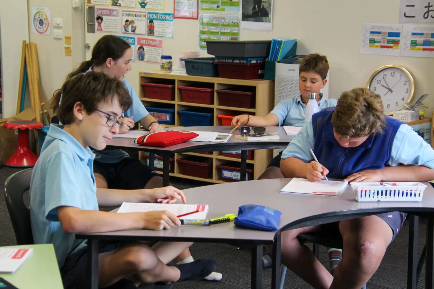 JOURNALS: Older students Luke Payne and Miller McCormack with Alex Payne and Carter Harwood working on a wellbeing activity. PHOTOS: Lynn Elder