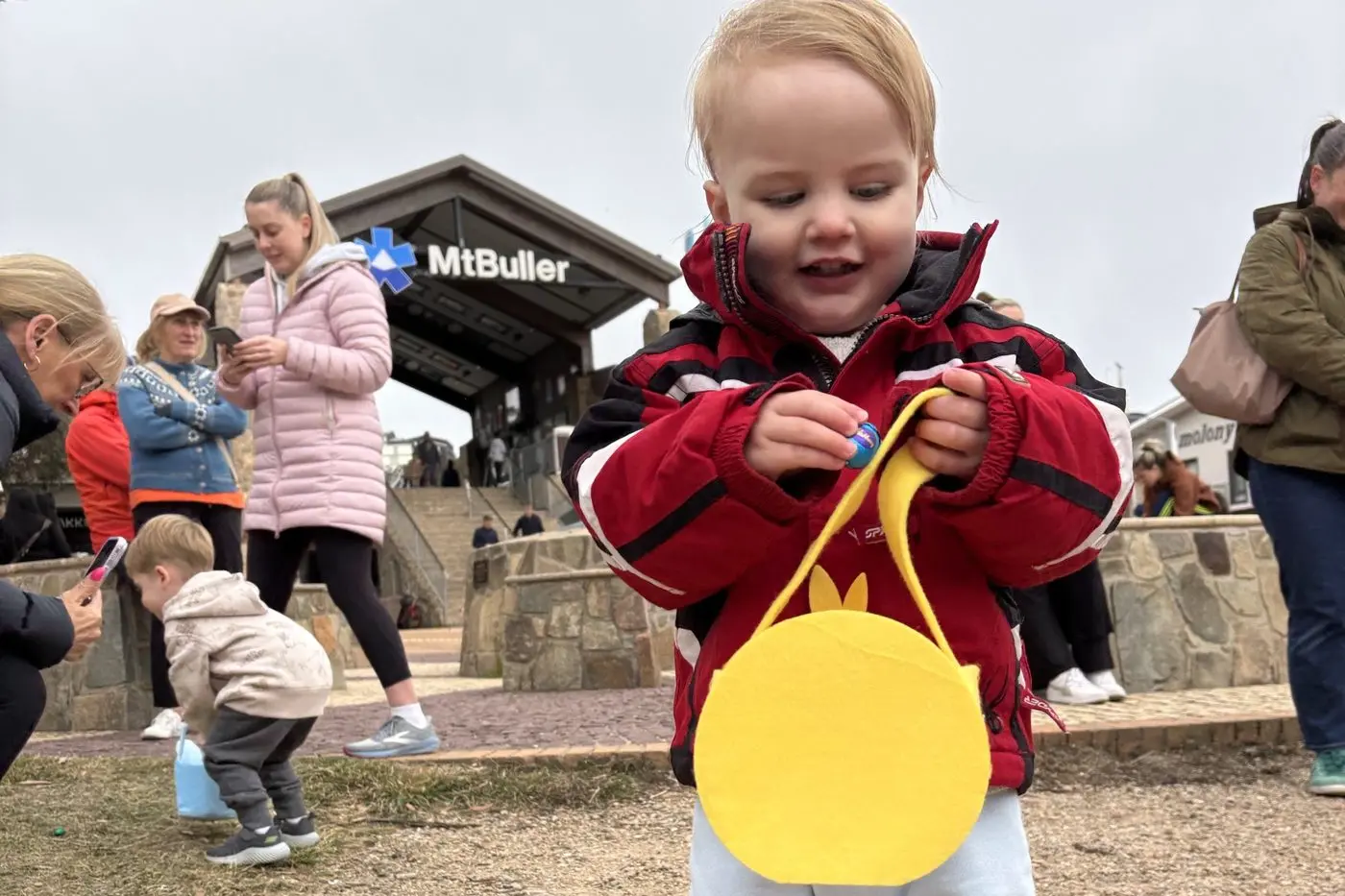 ONE FOR ME ONE FOR THE BASKET: Casper Clark came all prepared for his Easter egg hunt up on Mt Buller over the long weekend.