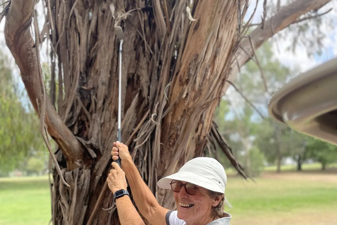A CHALLENGE: Marion Sargeant facing a challenge to reach her ball for her next shot. PHOTO: Supplied