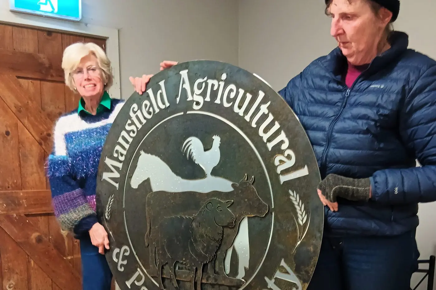 LOGO: New signage made by Chaos Concepts to grace the showgrounds entry gate was showed off by president Amanda Swaney (left) and committee member Sue Thompson Pabst at the AGM. PHOTO: Lynn Elder