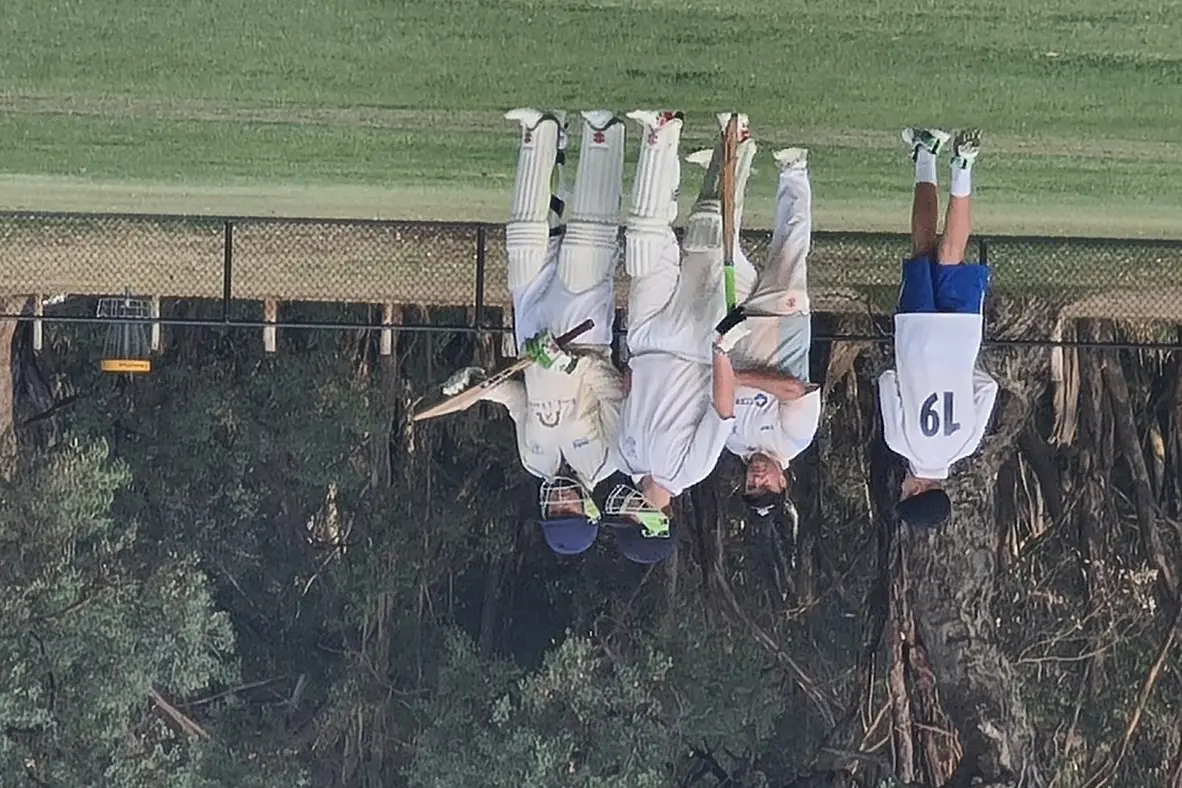 FAMILY AFFAIR: (From left) Felix O\\u2019Meara  and father Ross discuss tactics between overs.