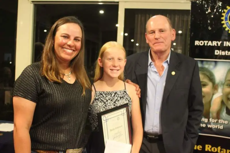 PLEASANT SURPRISE: Bridie Peterson (centre) was named the Junior Sportsperson of the Year last week. (From left) Magen Warlick, horsemanship coach and friend of Bridie Peterson who collected the award from Graeme Irving of High Country Smash Repairs. PHOTO: Sam Rouget