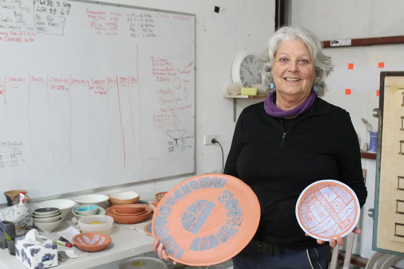 WORK IN PROGRESS: Joy Forrest with her hand-carved and painted ceramics before they go in the kiln.