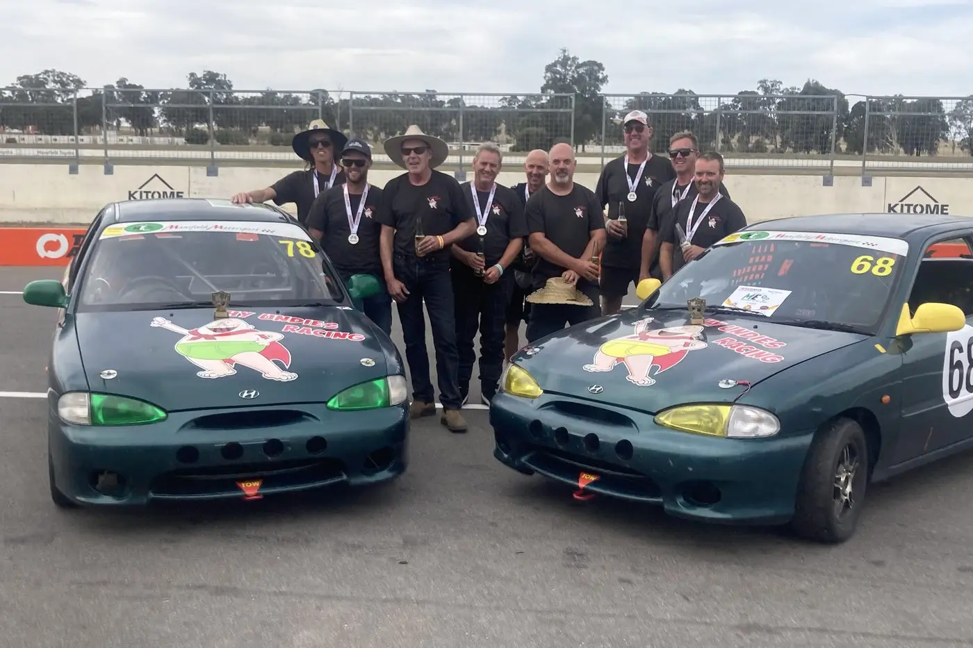 DOING US PROUD: The Hy Undies Race Team come together after 14 hours of racing to celebrate the double podium (from left): Kit Rundle,  Al Seaton, Dane Nye, Paul Allen, Steve Ward, Stu Wadsworth, Tony Brown, Brett Stevens and Brett Smith.