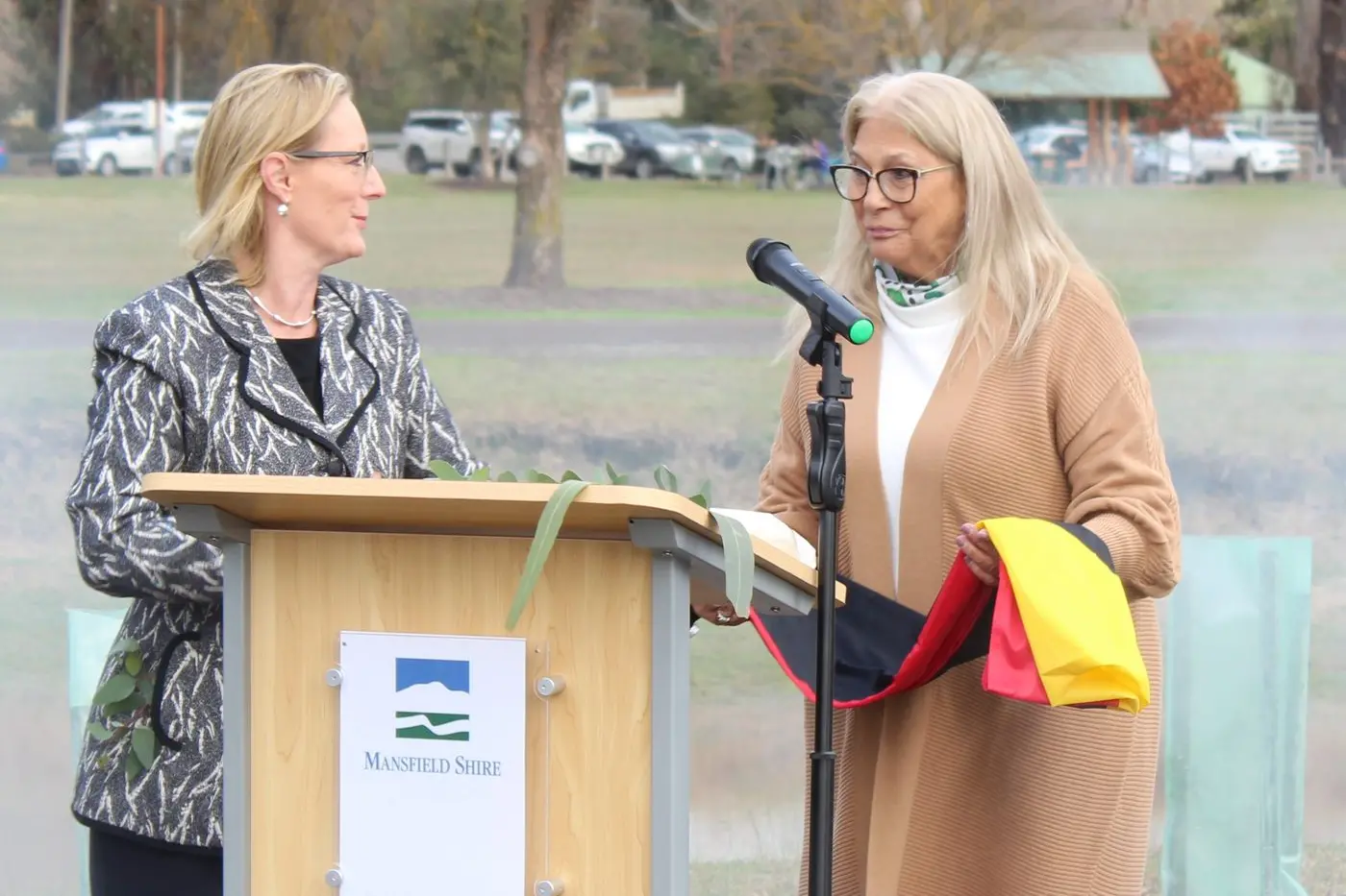 OPENING CEREMONY: Aunty Ann-Marie Fletcher accepts the Aboriginal flag from deputy leader of the Liberal Party Cindy McLeish at the opening of the Ngobi-An Gadhaba Garden. 