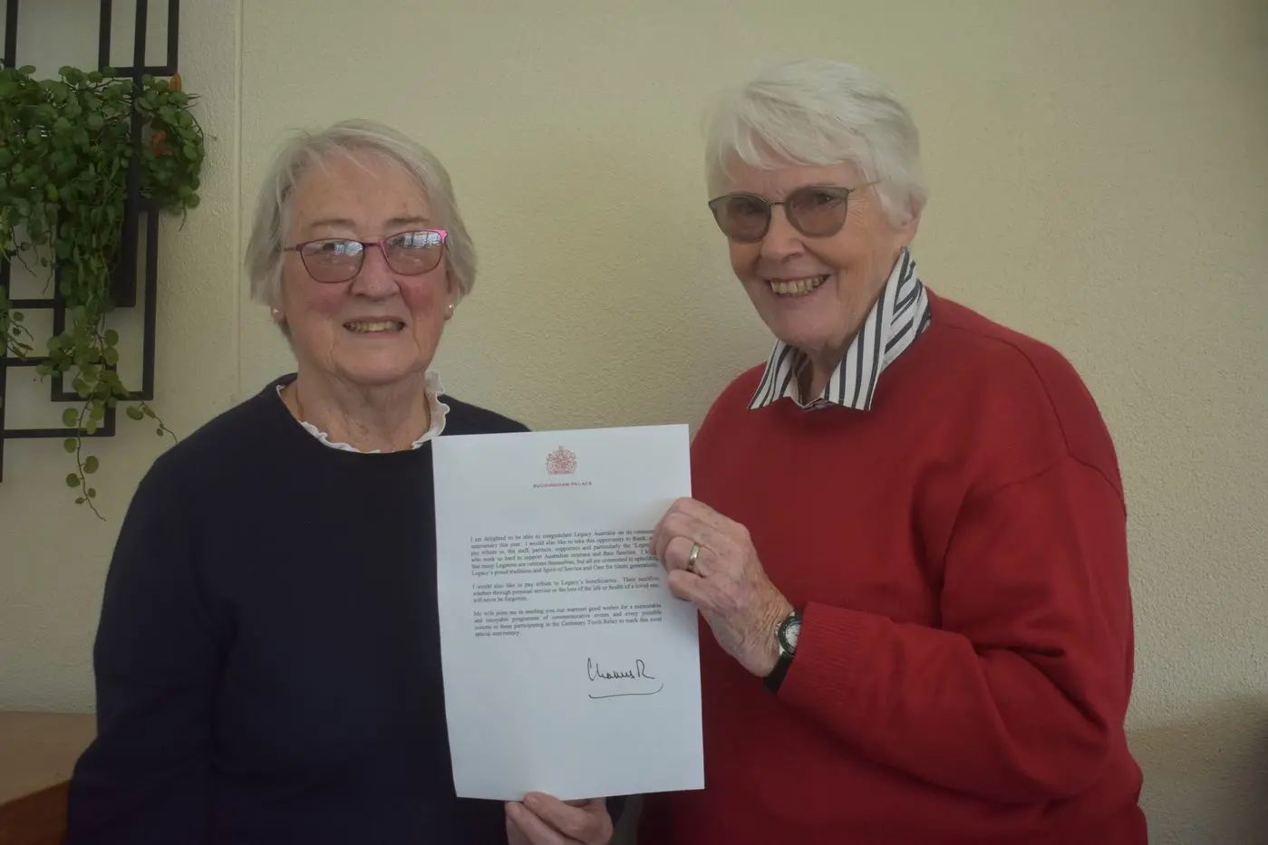 CARING FOR OTHERS: Legatees Sue Gardner (left) and Lois Neely are continuing their volunteer work with war widows and ex\\u2013service personnel and their families under the guidance of Legacy Australia. They are holding a copy of the letter sent by King Charles III. Id:40865