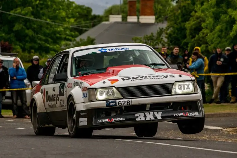 DON\\'T START YOUR ENGINES YET: Mick Downey and Jarrod Akker three-wheelin\\' around a corner during the Targa High Country, which has been postponed for this year.