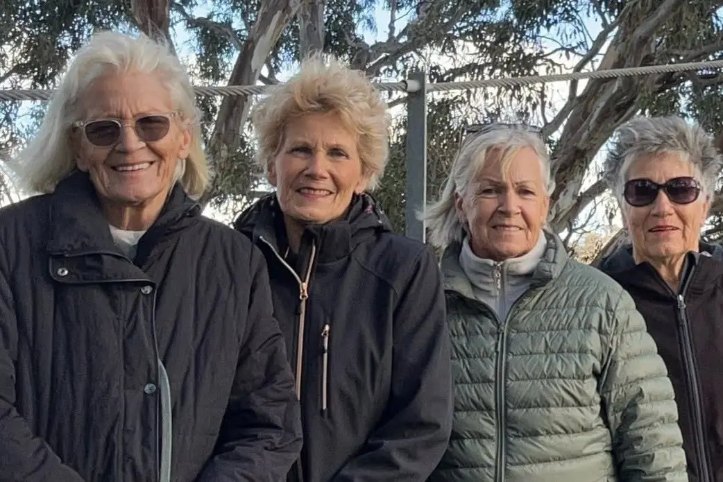 SISTERS AT BONNIE DOON: Rugged up and all smiles, the sisters paused for a windswept photo on the Bonnie Doon Bridge during their four-day reunion. PHOTO: Supplied